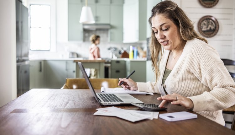 Vrouw bezig met papierwerk in haar huiskamer